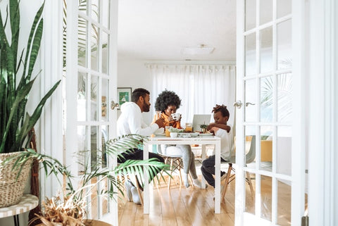 a family sitting in the dining area, representing tips for helping your kids adapt after a move