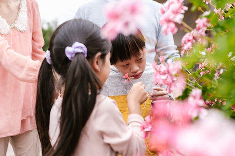 Two kids holding flowers