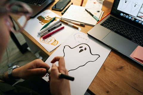 a girl making a Halloween pop-up card