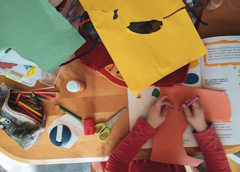 Kids playing with colorful paper during arts and crafts