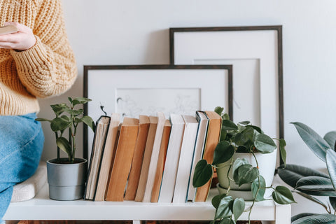 A minimalist book collection between two plants