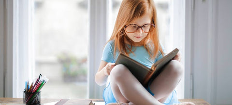 a girl sitting and reading a book