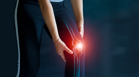 man holding knee with arthritis pain