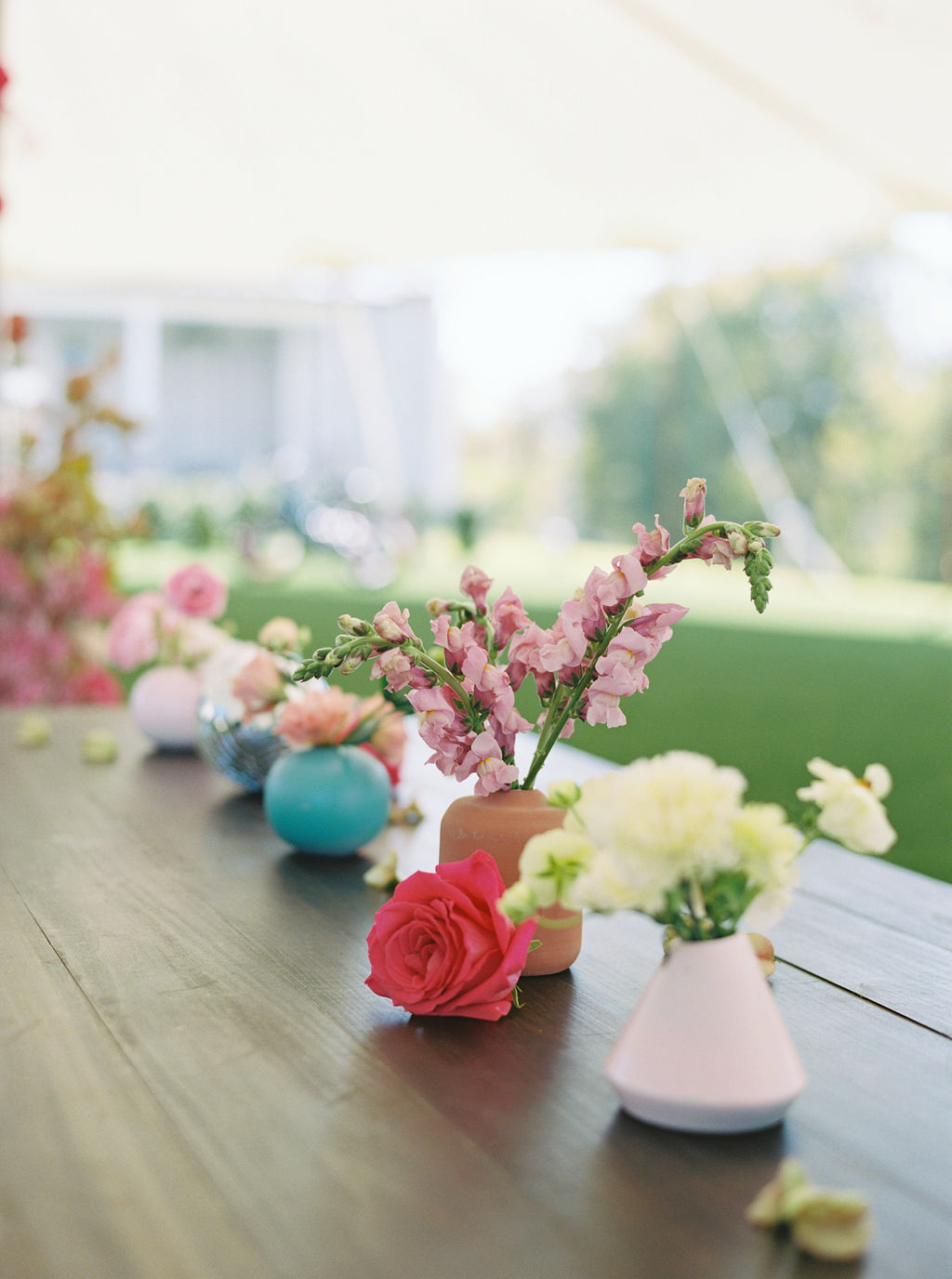 Bright bud vase floral centerpieces for Houston, TX birthday party
