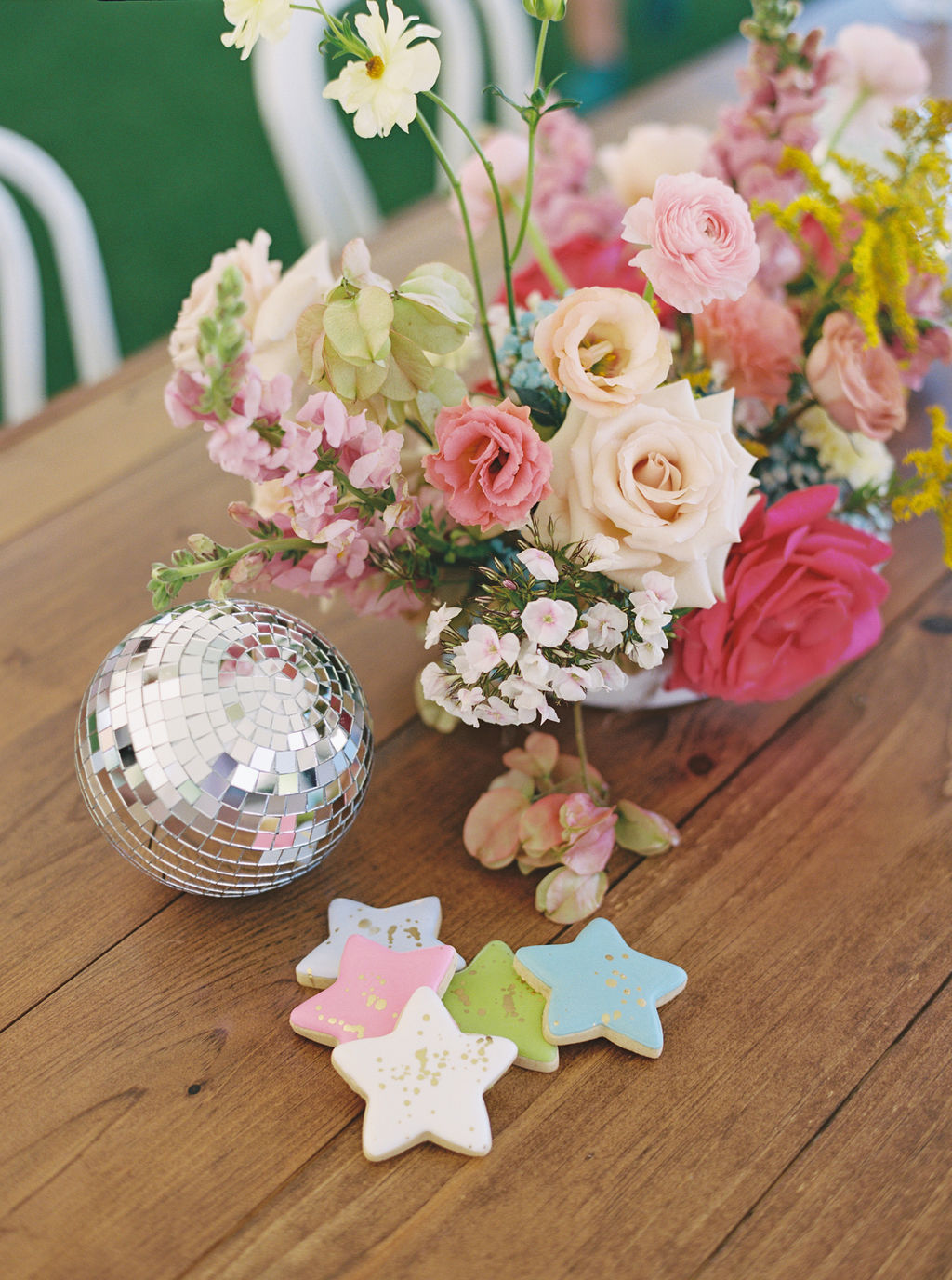 Bright floral centerpiece with disco balls for modern kids party decorations