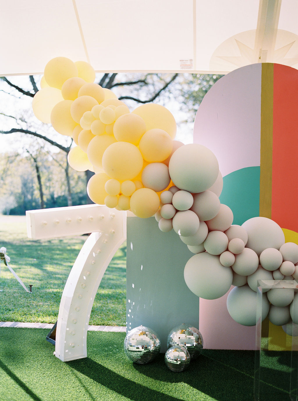 7 year old modern birthday party with balloon garland backdrop by Revelry Goods