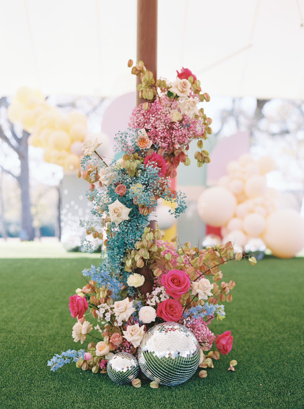 bright boho glam kids birthday party with flowers and disco balls