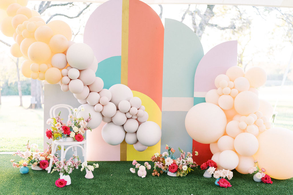 Modern chic backdrop with balloons and flowers by Revelry Goods in Houston, TX