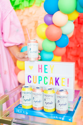 hey cupcake canned wine with fringe photo backdrop by revelry goods