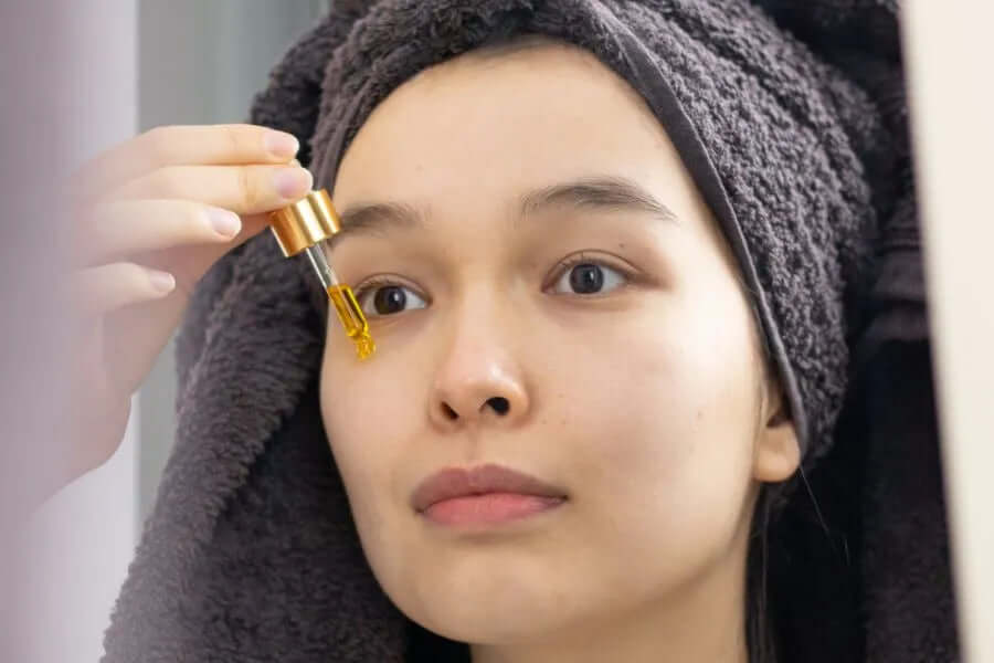 woman applying face serum