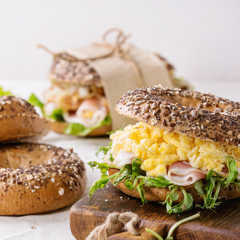 bagel with eggs ham and sprouts