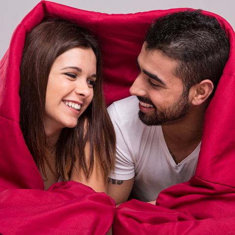 couple together under a blanket