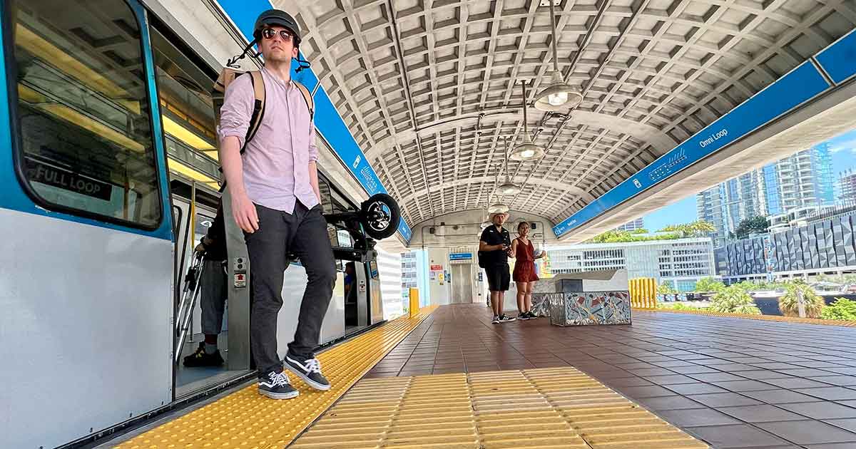 An electric scooter is parked on a metro station platform, ready to complement public transport as part of a sustainable urban travel solution.