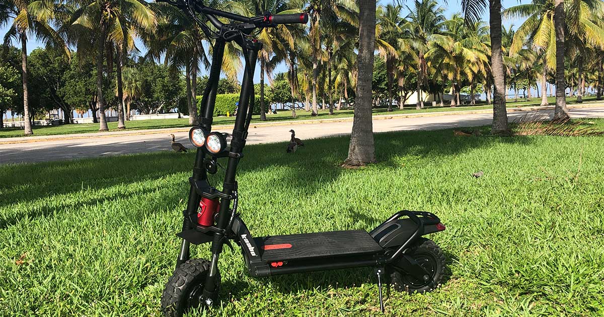 An electric scooter parked on a lush green lawn against a backdrop of palm trees, symbolizing the harmony between modern technology and tropical nature in combating climate change.