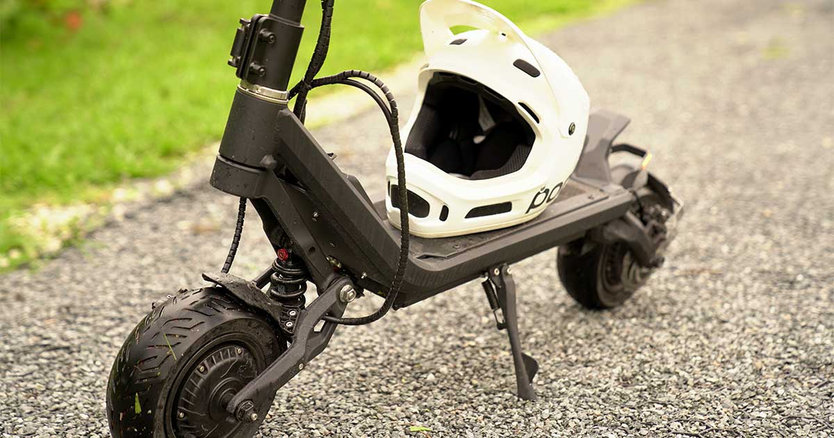 A high-performance electric scooter with a white racing helmet, poised for the start of a race, showcasing the thrill of electric scooter racing.