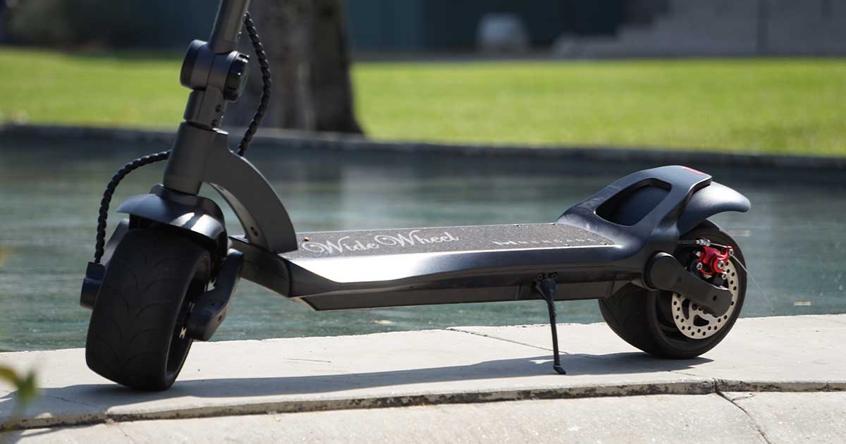 A high-quality electric scooter parked by a pool, emphasizing the importance of material and build quality for lifespan.