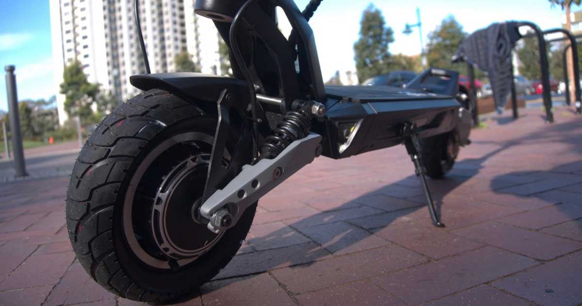 Close-up of an electric scooter's wheel, illustrating the robust tire tread and suspension that contribute to the safety standards of top scooters.