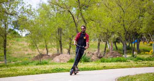 A person riding an electric scooter in a park