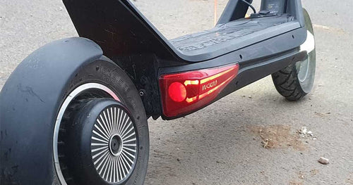 Close up image of a parked electric scooter ready to be charged