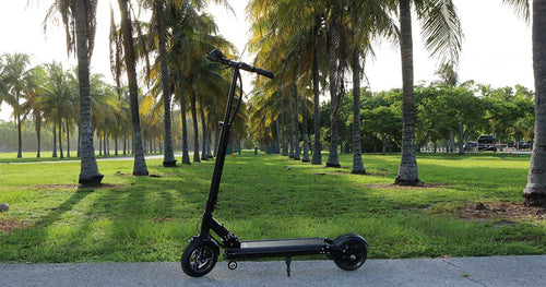 An electric scooter parked in a green field