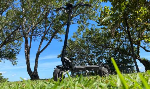 Electric Scooter in a field surrounded by greenery and trees