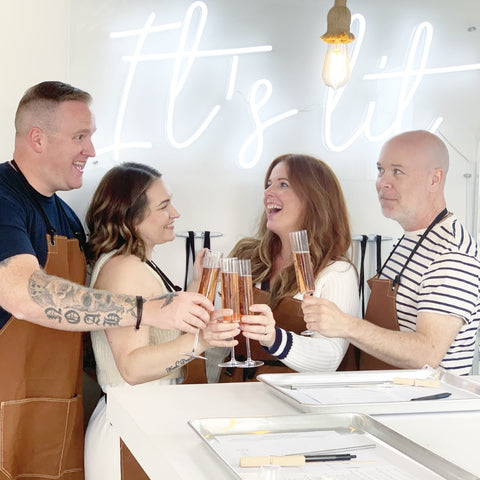 Two couples toasting at the Pour Your Own Candle Bar