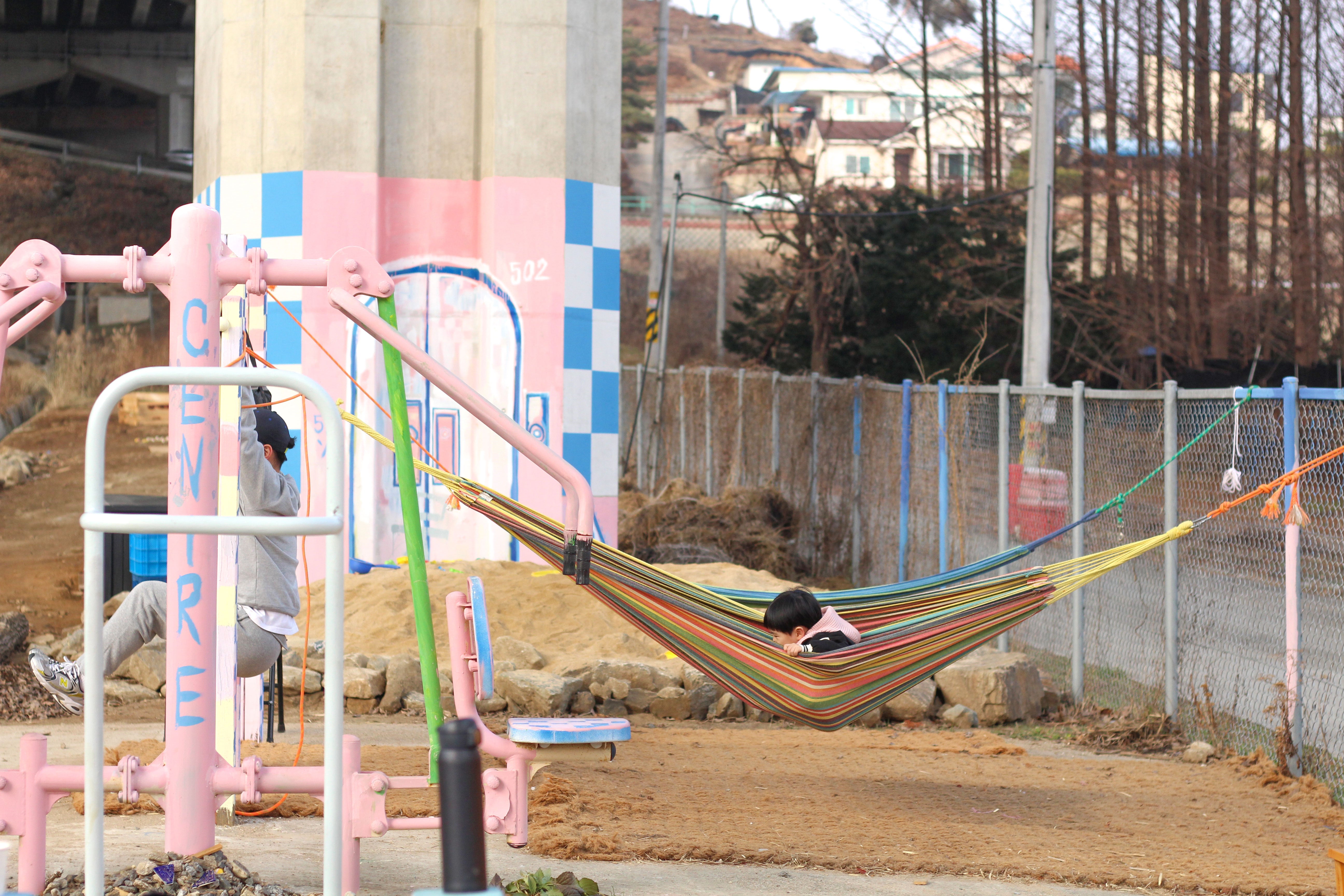 A child swinging precariously on a hammock at Bindoongplay.