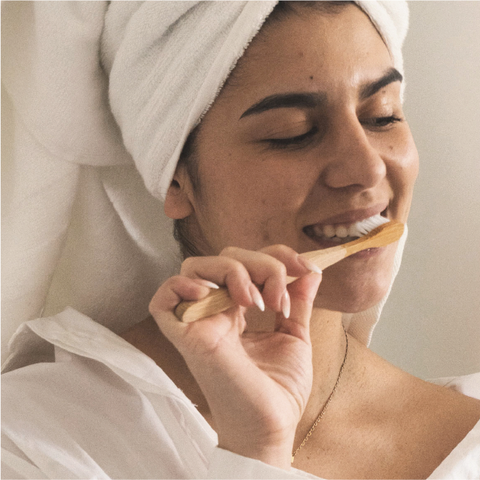 " Woman brushing her teeth - Natural toothpaste Natural toothpaste benefits - ATTITUDE"