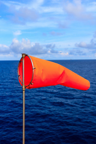 strong winds beach windsock orange