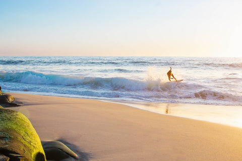 Skimboarding can be done by either wave skimming (as seen above) or sand skimming. We'll dive into how to learn both in this guide!