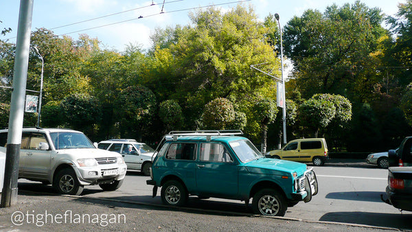 Teal Lada Niva parked on the street in Almaty, Kazakhstan.