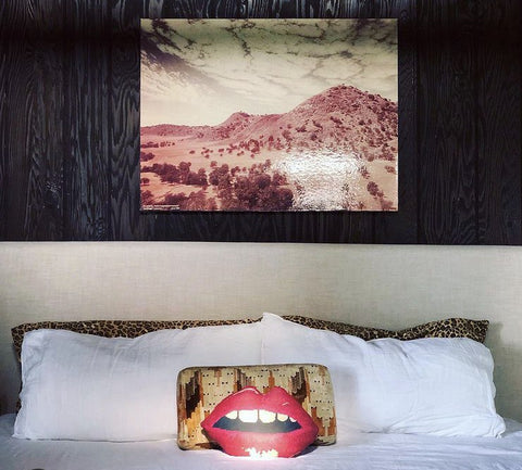 sculpted red lips pillow on bed