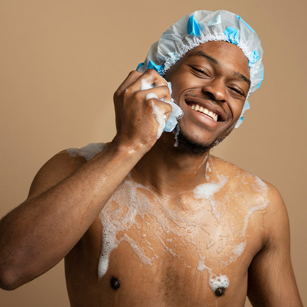 A black man cleansing his beard