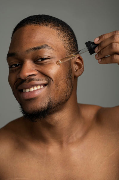 black man applying the best beard oil