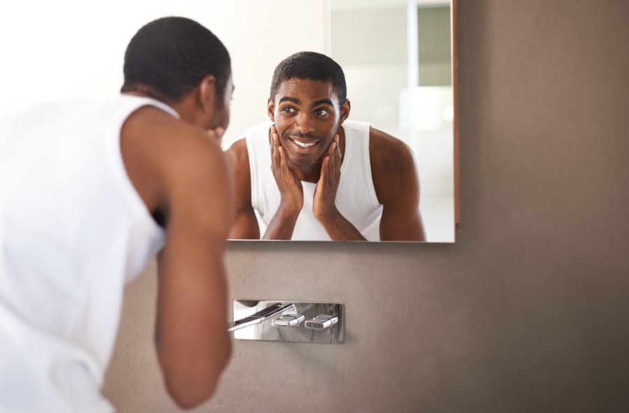 black man washing his beard with beard  shampoo