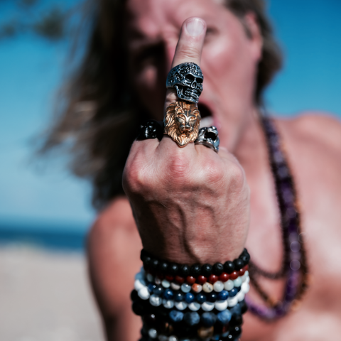 Male giving the middle finger wearing rings and bracelets