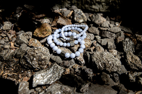 Pastel Gemstones laying on a rock.