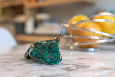 Malachite Gemstone Cluster sitting on Kitchen Table.