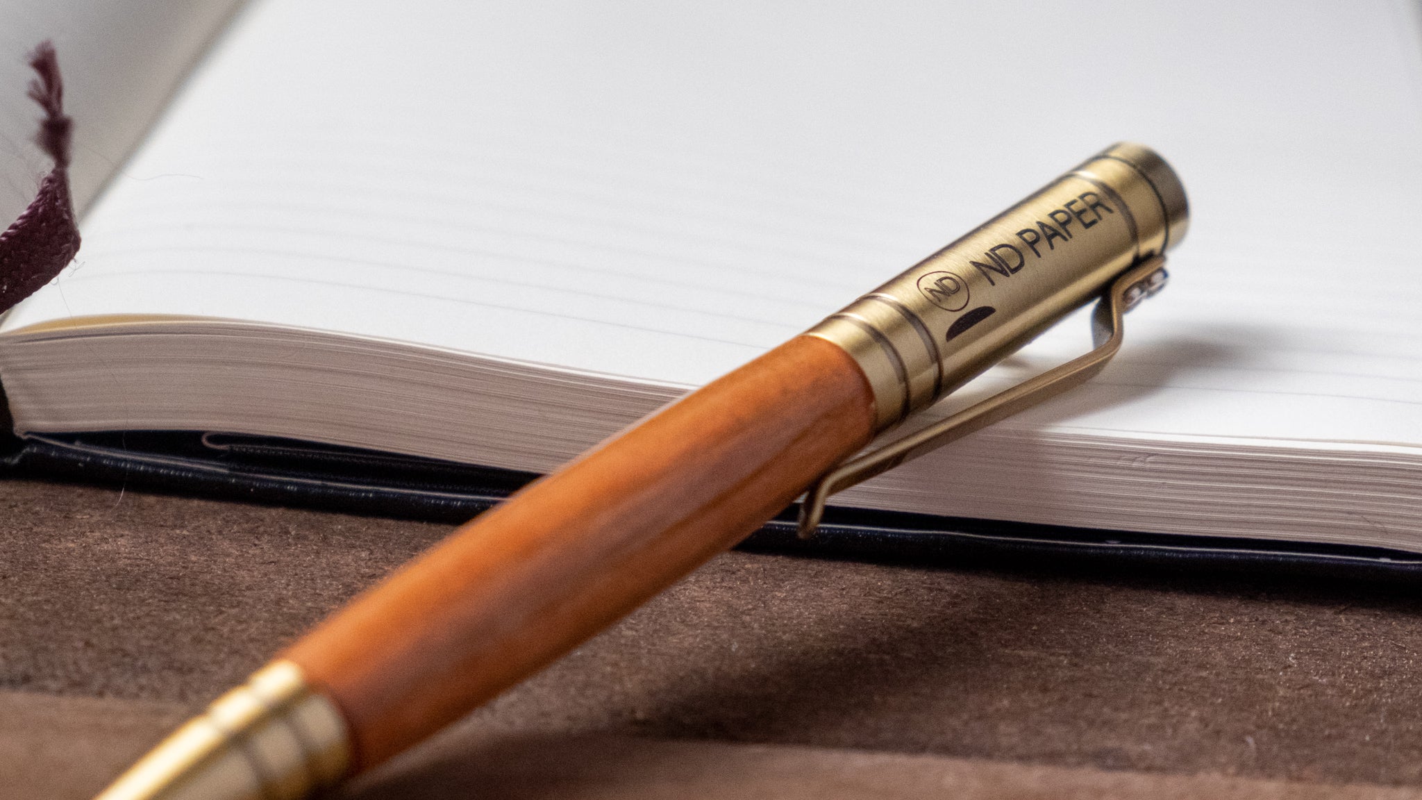 An Aroostook ballpoint pen customized with company logo and wood chosen by the client. 