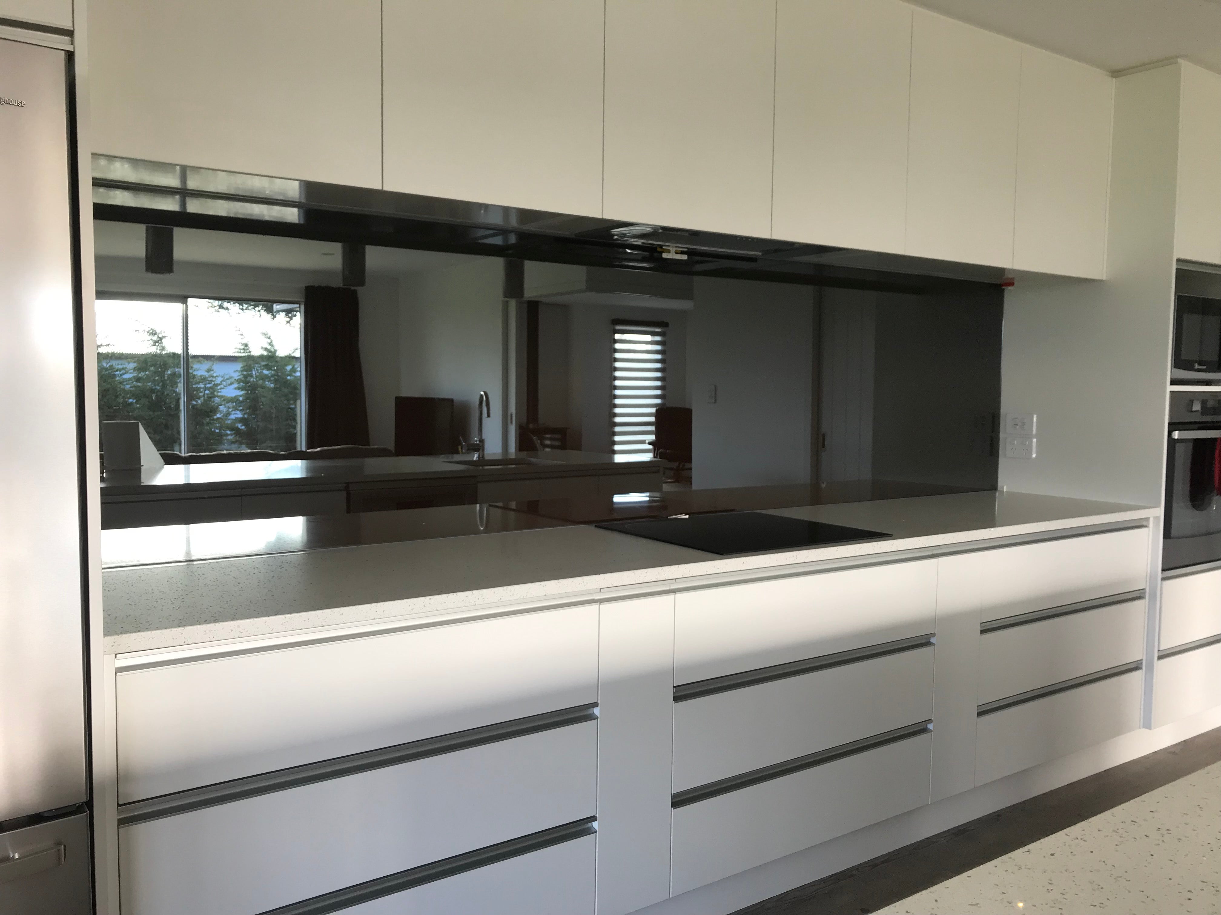 Mirrored grey tint kitchen splashback