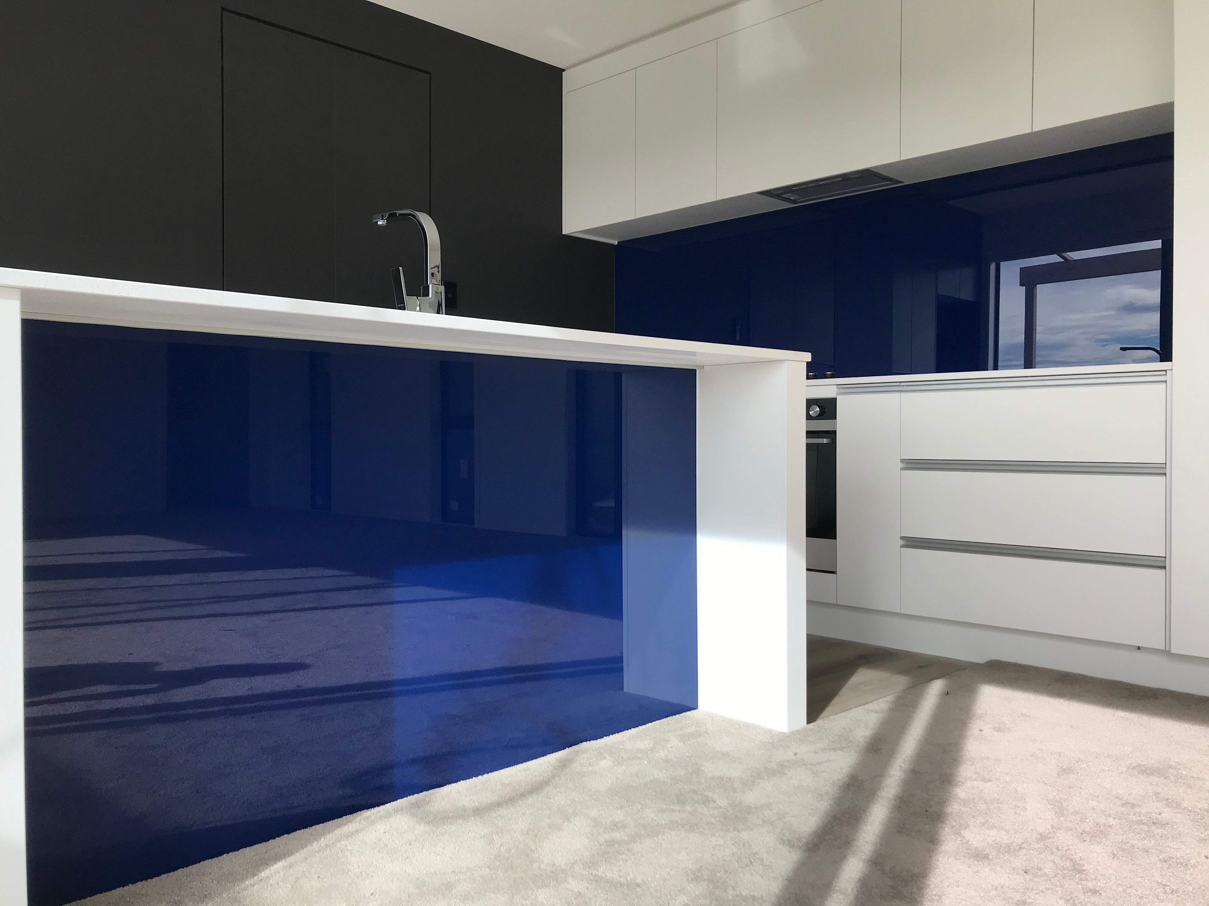 Blue kickboard and splashback in matching toughened glass