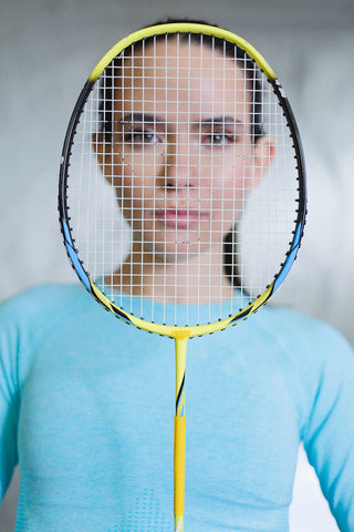 Badminton Woman Looking through a Badminton Racket