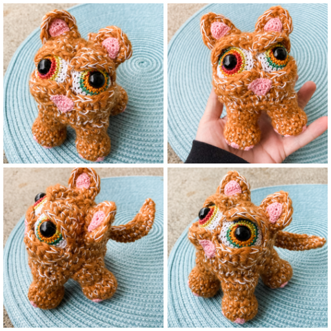 4 different angle photos of an orange crocheted cat doll with big rainbow eyes on a sky blue mat.