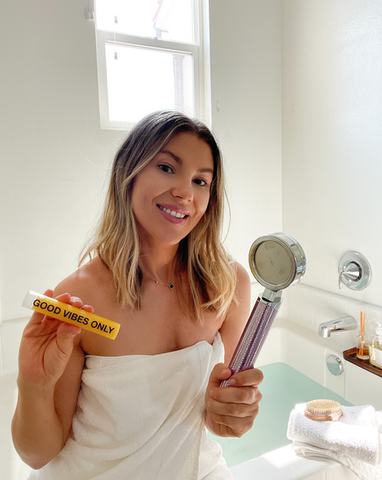 girl with shower head and vitamin c shot