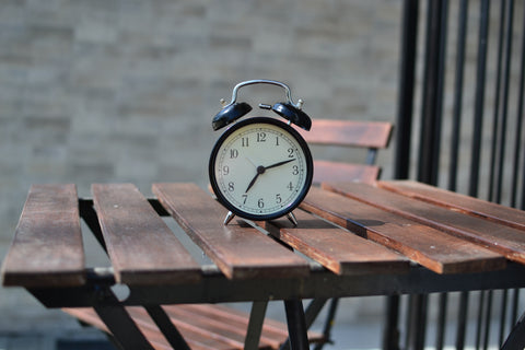 Classic two-bell alarm clock on wood table