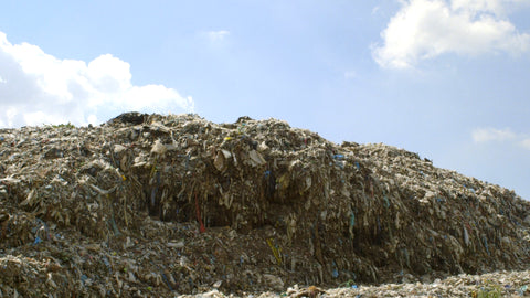 Still from 'The True Cost' (2015) of a mound of textile waste