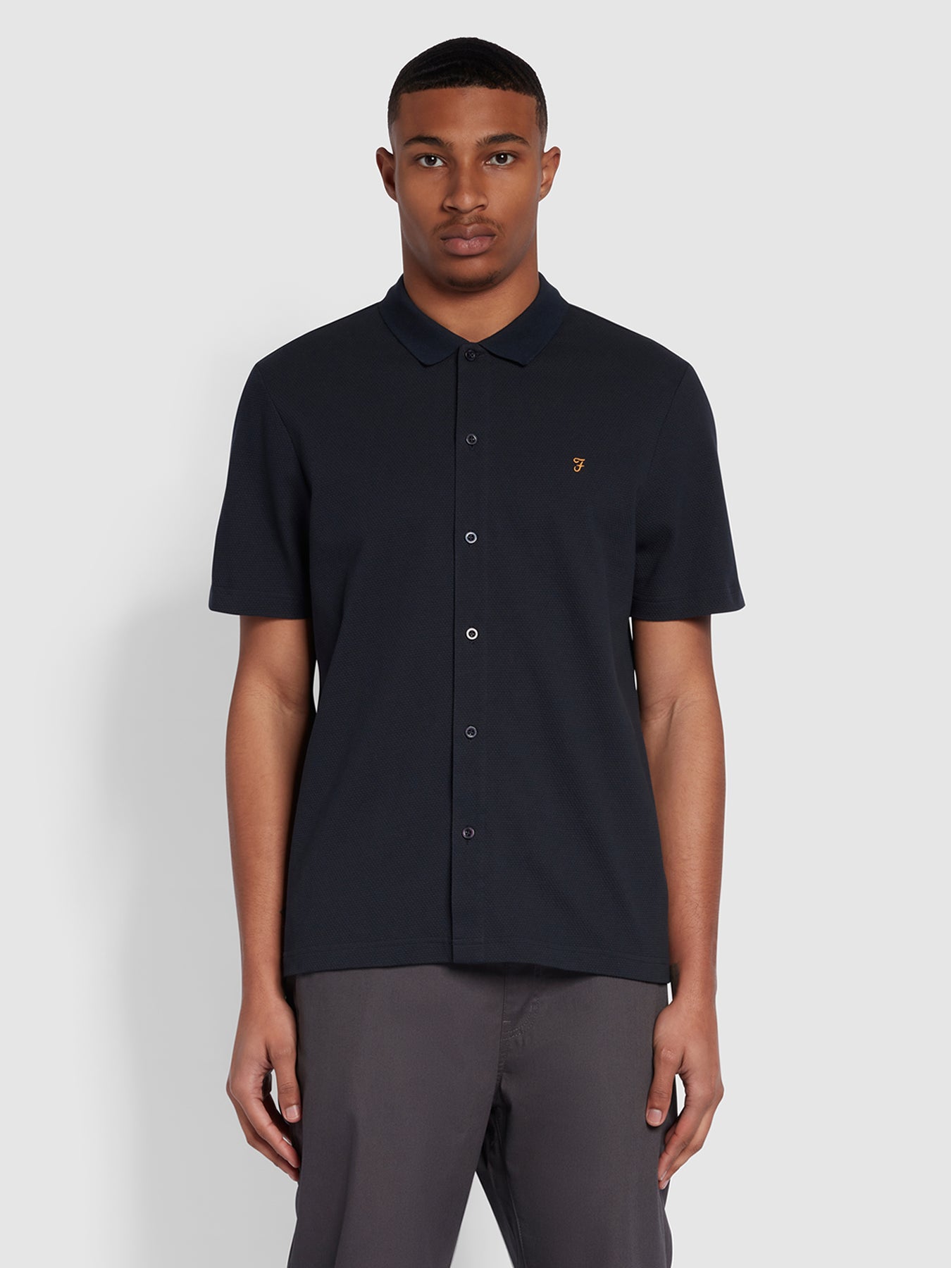 View Lesser Regular Fit Bubble Stitch Polo Shirt In True Navy information