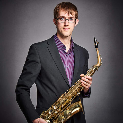 Alastair Penman holding alto saxophone