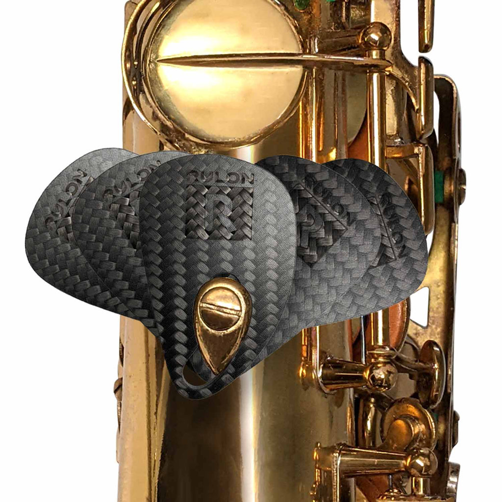 The carbon fiber RULON saxophone thumb rest fanned out on a tenor saxophone.