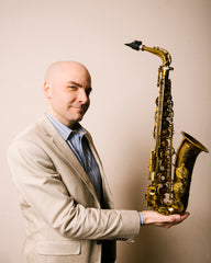 Saxophonist Rulon Brown holding a Selmer Mark VI alto saxophone 